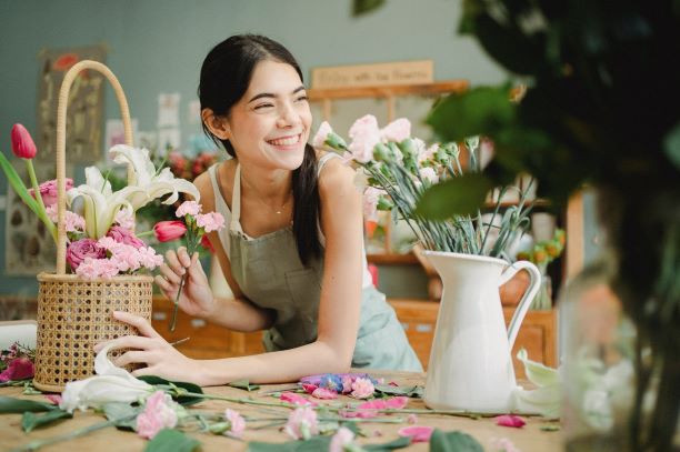 image of girl in flower shop pruning flowers